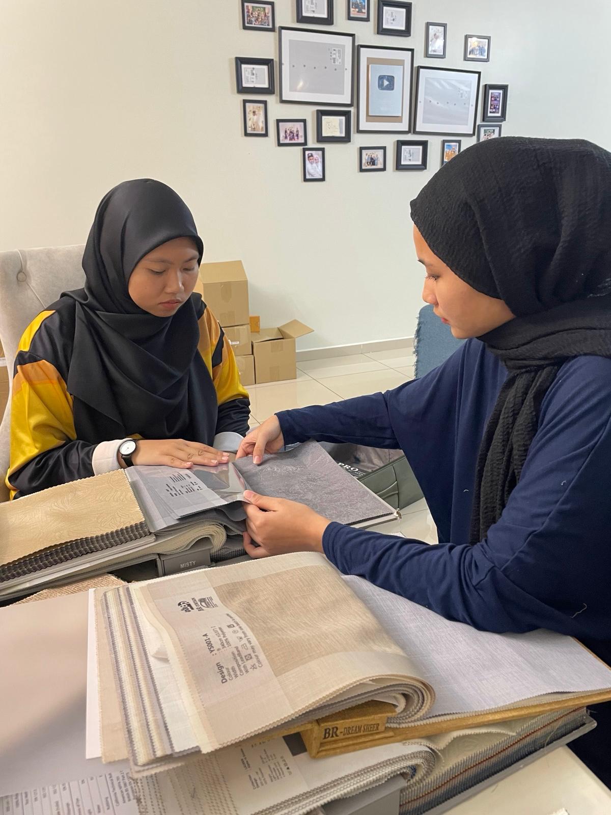 A client choosing fabric samples with a consultant